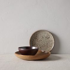 a bowl and plate sitting on top of a table