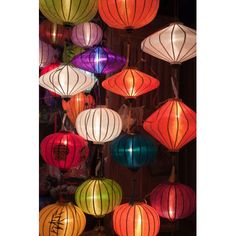 many colorful lanterns hanging from the ceiling