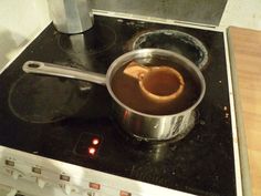 a pot on top of a stove filled with liquid