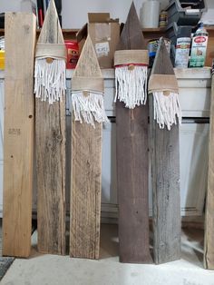 three wooden boards with tassels on them sitting next to each other in a room