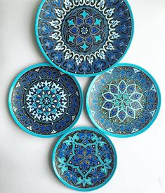 four blue plates with intricate designs on them