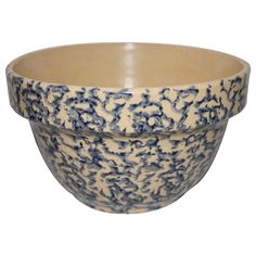 a blue and white bowl sitting on top of a table