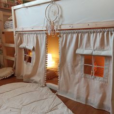 there is a bunk bed with curtains on it