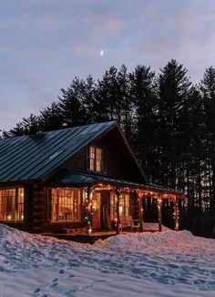 a log cabin is lit up with christmas lights