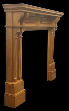 a wooden fireplace surround with an arch in the center and two columns on either side