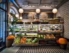 a store filled with lots of fresh fruits and veggies on top of shelves