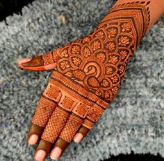 a woman's hand with hennap on it, showing the intricate design