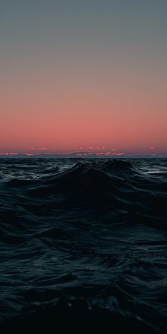 the sun is setting over the ocean with waves