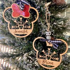 two wooden ornaments hanging from a christmas tree