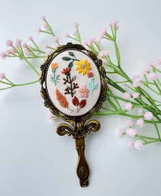 📍  About this Embroidered mirror: The beautiful embroidered mirror is made by skilled traditional embroiders in Vietnam. The compact mirrors are easy to carry, foldable, compact and small enough to fit in your pockets and bags.  The motifs on the mirror are embroidered beautiful flowers field, wild flowers. The mirrors come with a handle. Dimension: 7x15cm 📍  You buy this for yourself or give it as a perfect sweet gift for: - Wedding or bridesmaid gifts  - Bachelorette gifts, Back to school gi Vintage Pocket Mirror, Personalized Pocket Mirror, Mirror With Flowers, Pocket Mirror Vintage, Compact Mirror Rose, Embroidery Mirror, Vintage Compact Mirror, Flowers Field, Embroidered Pocket