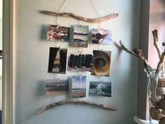 the wall is decorated with pictures and driftwood