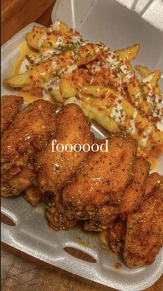 chicken wings, french fries and macaroni in a styrofoam container