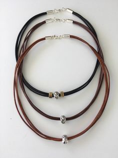 This silver Lion Bead on leather choker/necklace has a front and back pattern to the bead on three strands of 2mm leather. Silver end caps with a lobster claw clasp finish the cord endings for ease while removing or wearing the necklace. Available in gray, natural brown, copper brown, and black leather with various length options to choose from during check-out. Handcrafted in my St. Augustine, Florida workshop. This necklace arrives wrapped in tissue paper inside an organza bag with a decorativ Fiance Birthday, Braided Leather Necklace, Brown Copper, Leather Choker Necklace, St Augustine Florida, Copper Brown, Saint Augustine, Leather Chokers, Gift Labels