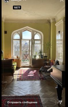 a living room filled with furniture and windows