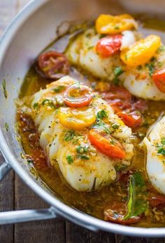 some kind of food that is in a pan on a wooden table and ready to be eaten