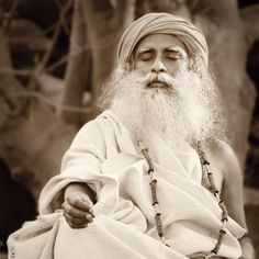 an old photo of a man with white hair and beard wearing a turban