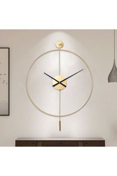 a clock that is on the side of a wall next to a table and lamp