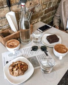 a table topped with plates of food and drinks