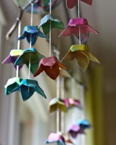 an origami bird mobile hanging from a ceiling