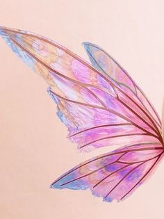 a pink and blue butterfly flying in the air with its wings spread out to look like it's been painted