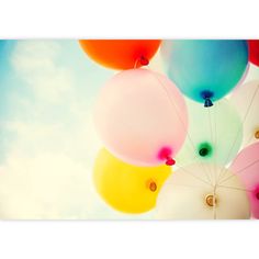 colorful balloons floating in the air on a sunny day