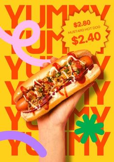 a hand holding a hot dog with toppings on it in front of a colorful background