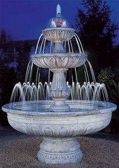 a large white fountain with water spouting from it's sides