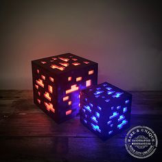 two glowing cubes sitting on top of a wooden table