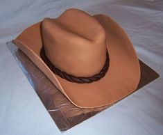 a brown cowboy hat sitting on top of a table