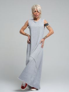 Our grey maxi dress is the epitome of laid-back chic, made from soft viscose that drapes beautifully for a comfortable yet stylish look. Its sleeveless design and subtle scoop neckline offer a casual elegance that's perfect for sunny days or layered under a jacket when the evening cools down. FEATURES:Sleeveless with a relaxed fit and a long, flowing silhouette. Ideal for leisurely weekend wear or as a base for accessorizing100% Handmade. SIZE & FIT: Fit: A relaxed fit with room to moveModel is wearing size Small or S/M View our SIZE CHART before ordering MATERIALS & CARE: Content: 65% Cotton, 35% Polyester Care: Machine wash on cold (30ºC) with a mild detergent. SHIPPING: Made to order, the processing time is 15 working days This item will be shipped via DHL Casual Gray Maxi Dress For Summer, Casual Gray Sleeveless Maxi Dress, Gray Long Summer Dress, Flowy Sleeveless Dresses With Side Slits, Long Gray Summer Dress, Gray Lagenlook Summer Dress, Sleeveless Gray Maxi Dress For Spring, Casual Sleeveless Maxi Dress For Loungewear, Flowy Sleeveless Viscose Maxi Dress