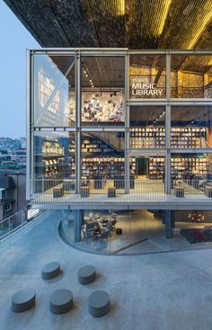 the inside of a library with lots of books on it's walls and stairs