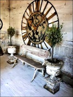 an old room with two clocks on the wall and some benches in front of it