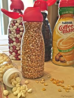 nuts, coffee mate and peanut butter are sitting on a table next to each other