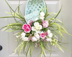 a door hanger decorated with flowers and a welcome home sign