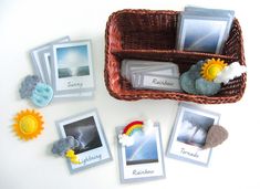 a basket filled with pictures and magnets on top of a white table next to other items