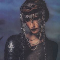 a woman with chains and beads on her head