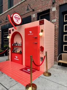 a red vending machine sitting on top of a sidewalk