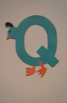 the letter q is made out of paper and has an image of a duck on it