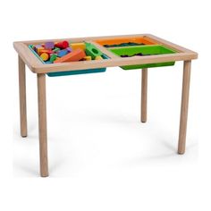 a child's wooden table with two trays and toys on the bottom shelf