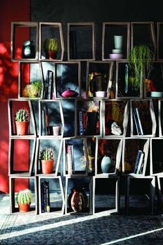 a book shelf filled with books and plants