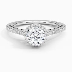 a white gold engagement ring with round diamonds