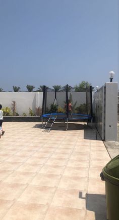 two people playing frisbee on the roof of an apartment building with privacy screens