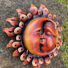 a sun face with many eyes on the ground