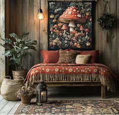 a bed with a red blanket on top of it in front of a wooden wall