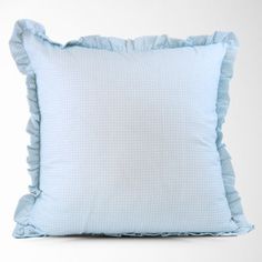 a blue pillow with ruffled edges on a white background