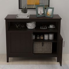 there is a shelf with pictures and bowls on it next to a wall mounted painting