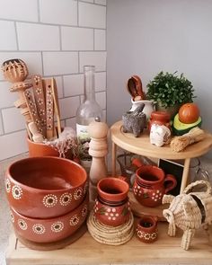 many clay pots and spoons on a table