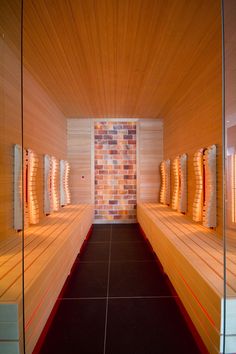 a row of wooden benches sitting next to each other on top of a tiled floor