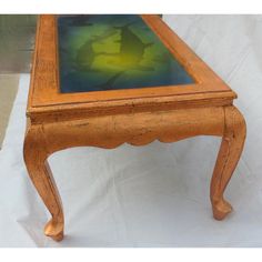 an old wooden table with a glass top