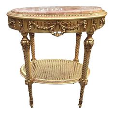 an ornately decorated table with marble top and wicker base, on white background